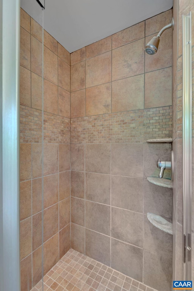 bathroom with a tile shower