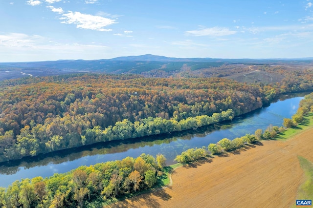 drone / aerial view featuring a water and mountain view