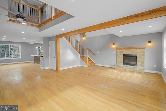 unfurnished living room featuring a fireplace and light hardwood / wood-style floors