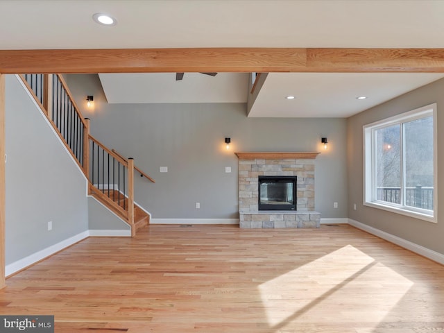 unfurnished living room featuring stairway, wood finished floors, beamed ceiling, and recessed lighting