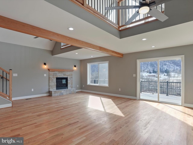 unfurnished living room with light wood-style flooring, a ceiling fan, beam ceiling, baseboards, and recessed lighting
