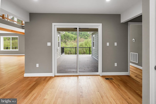 entryway featuring light wood-style flooring, baseboards, and visible vents