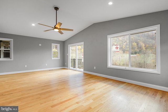 empty room featuring vaulted ceiling, ceiling fan, and light hardwood / wood-style floors