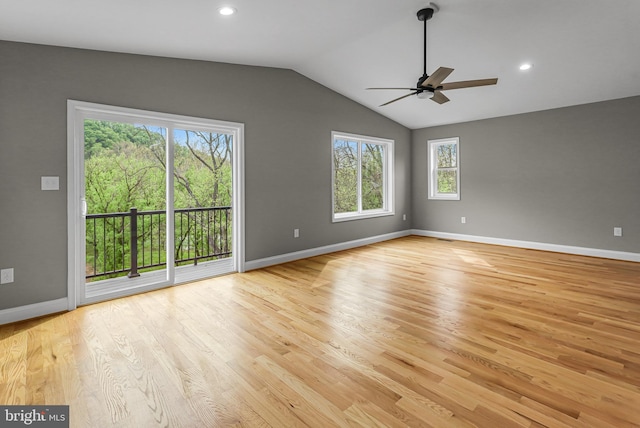 unfurnished room featuring baseboards, light wood-style floors, ceiling fan, and vaulted ceiling