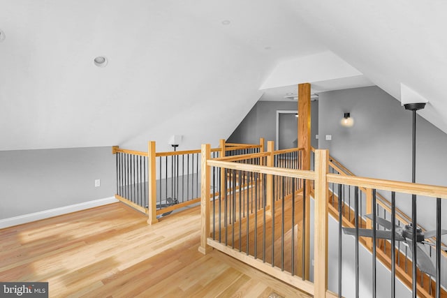 bonus room featuring wood-type flooring and vaulted ceiling