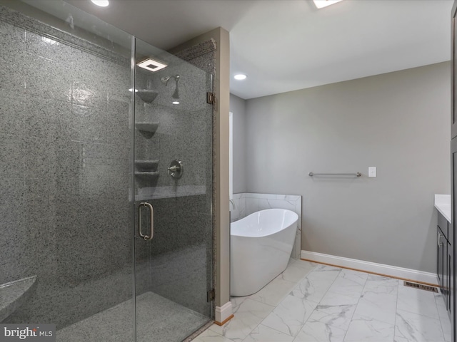 bathroom featuring a stall shower, a soaking tub, baseboards, marble finish floor, and recessed lighting