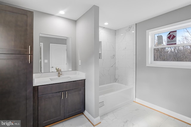 bathroom featuring vanity and tiled shower / bath