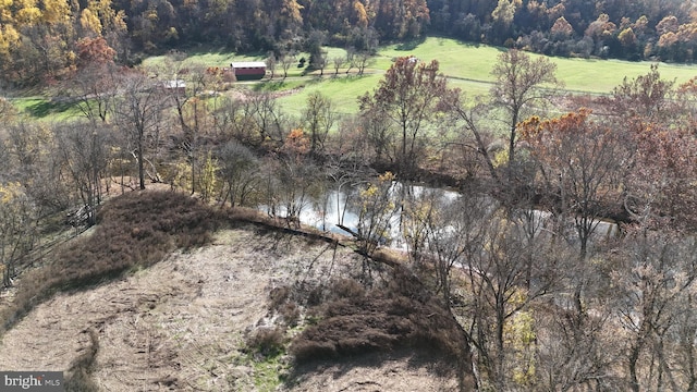 drone / aerial view featuring a water view and a rural view