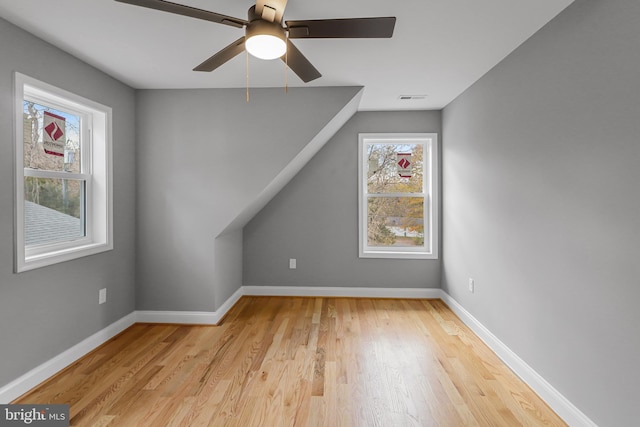 additional living space with ceiling fan and light wood-type flooring