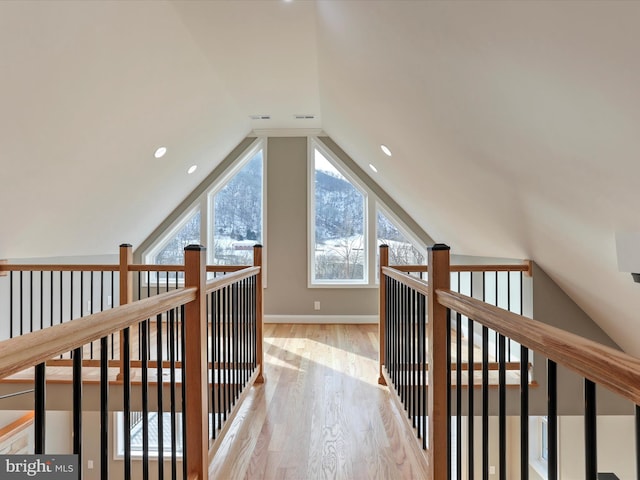 additional living space featuring lofted ceiling, light wood-style flooring, and recessed lighting