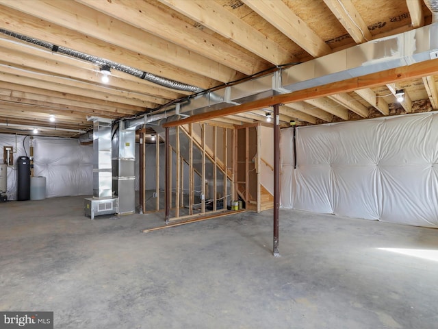 unfinished basement with stairway and heating unit