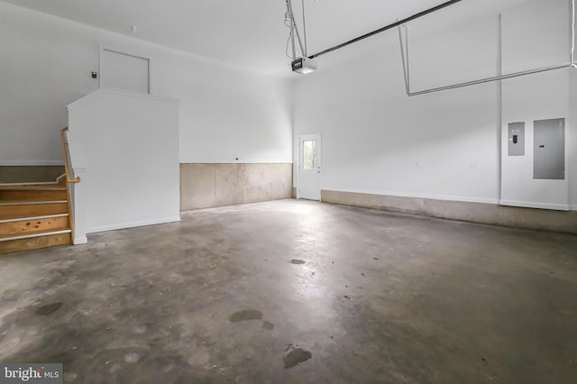 garage with electric panel and a garage door opener