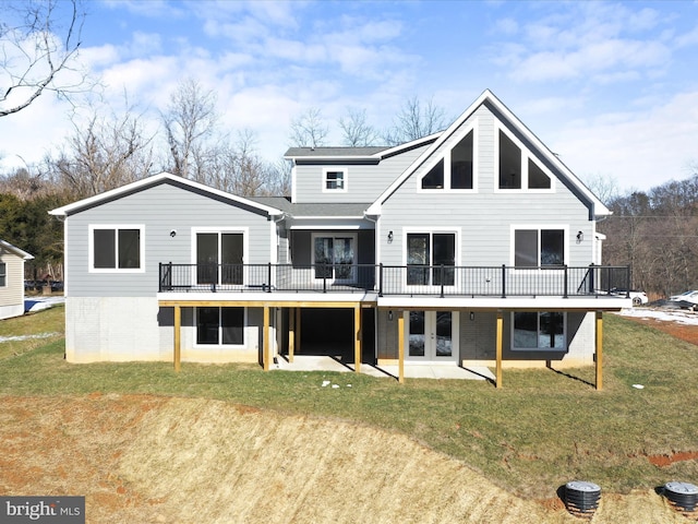 back of property featuring a patio area, a deck, and a lawn