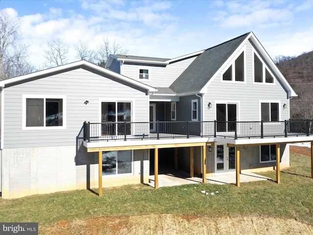 rear view of house with a yard, a patio area, and a deck