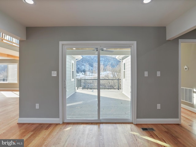 doorway with light wood-type flooring