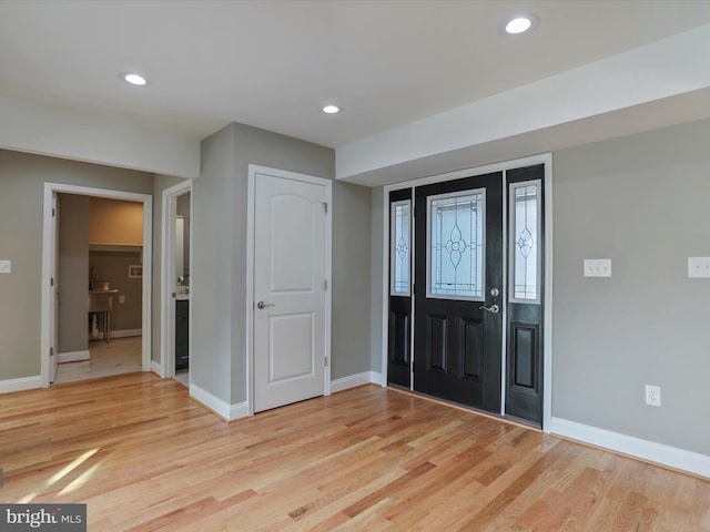 foyer entrance featuring light wood finished floors, baseboards, and recessed lighting