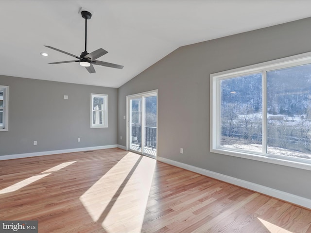 spare room with lofted ceiling, light wood-style flooring, recessed lighting, baseboards, and ceiling fan