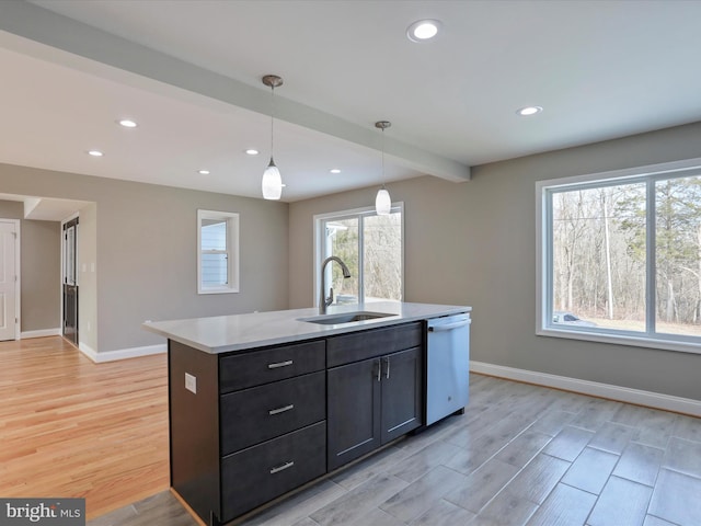 kitchen featuring a sink, a kitchen island with sink, recessed lighting, dishwasher, and light wood-style flooring