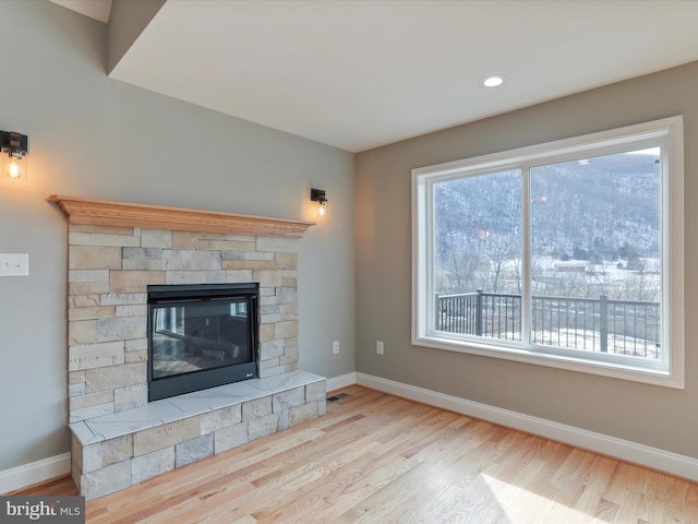 unfurnished living room featuring a fireplace and light wood-type flooring