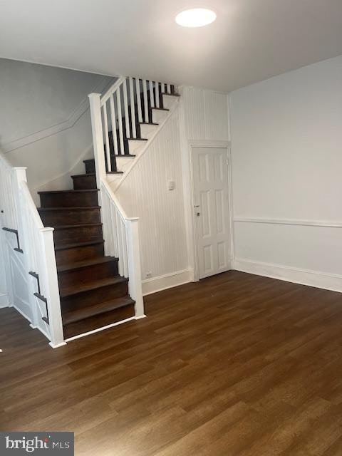 stairway with hardwood / wood-style flooring