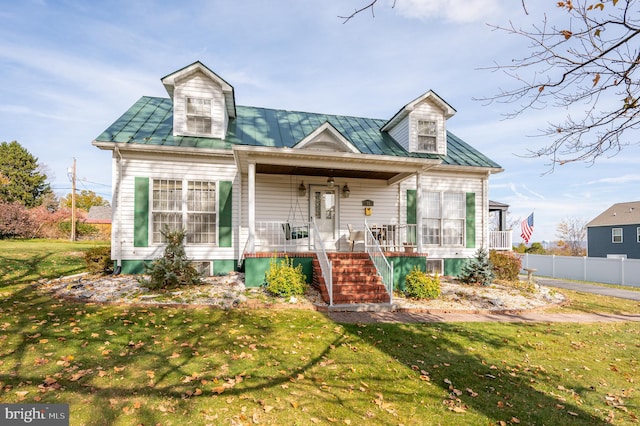 cape cod house with a porch and a front lawn