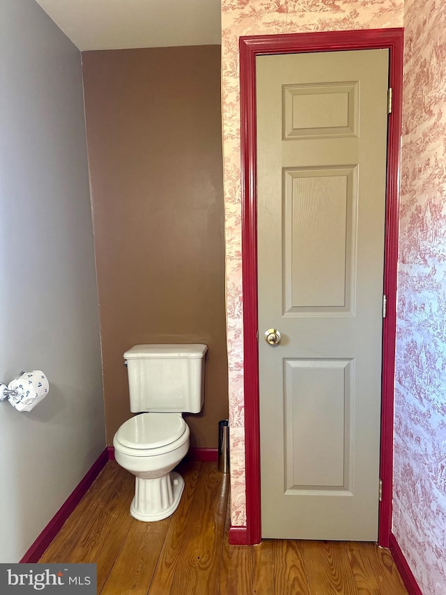 bathroom with hardwood / wood-style floors and toilet