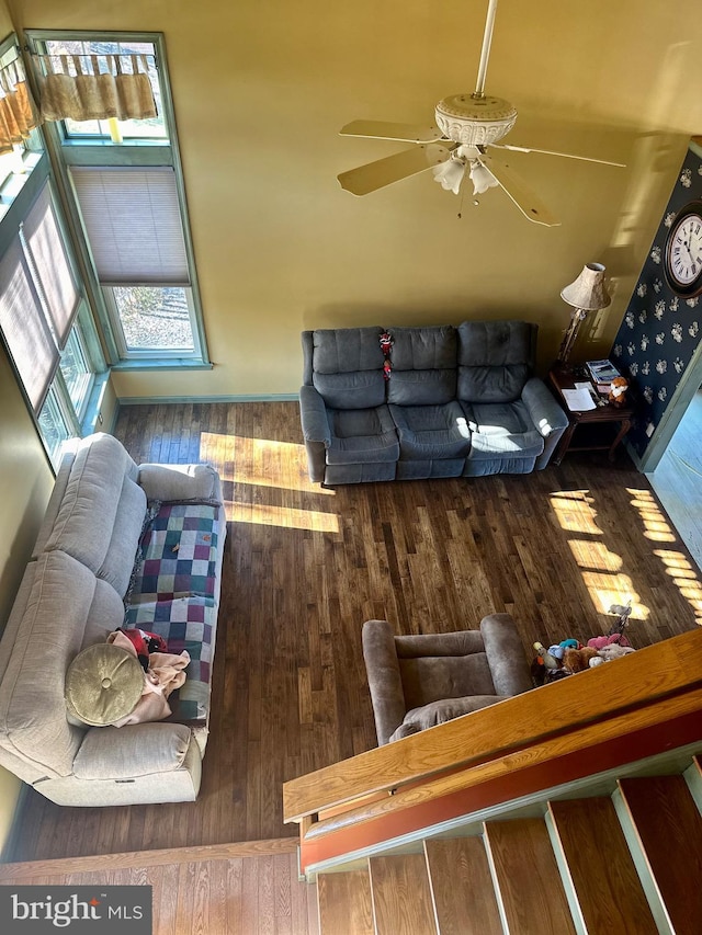 living room with wood-type flooring and ceiling fan