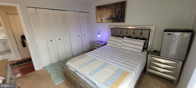 bedroom featuring light carpet and a closet