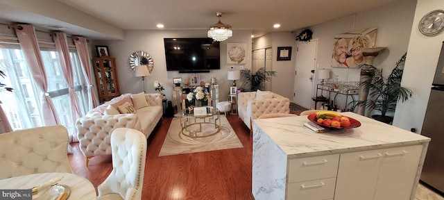 dining room with an inviting chandelier, light hardwood / wood-style flooring, and a wealth of natural light