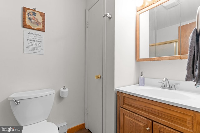 bathroom featuring vanity and toilet