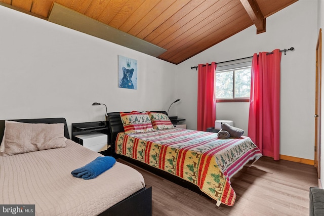 bedroom featuring vaulted ceiling with beams, light hardwood / wood-style flooring, and wooden ceiling