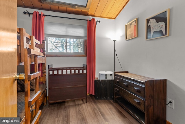 bedroom with hardwood / wood-style floors and wooden ceiling