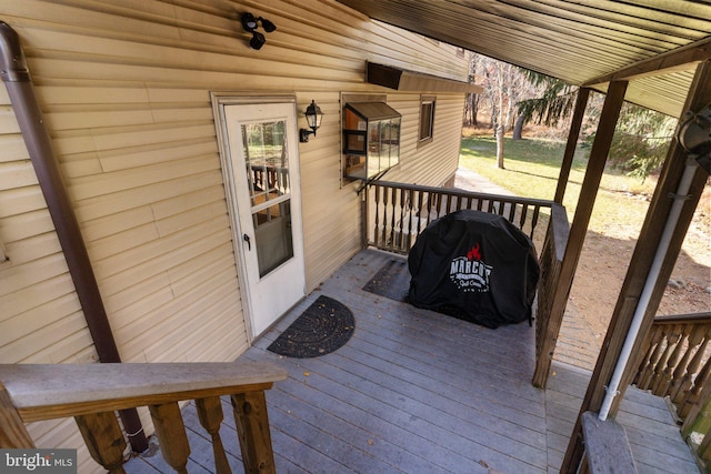 wooden deck with a grill