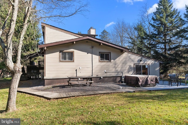 rear view of property with a yard, a patio area, and a wooden deck