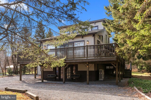 rear view of house with a wooden deck