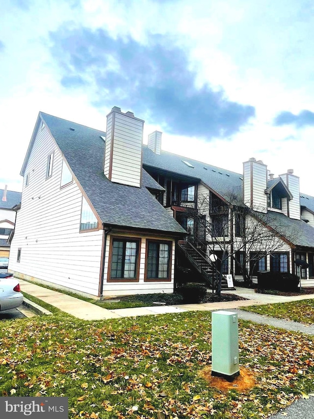 view of side of home with a yard