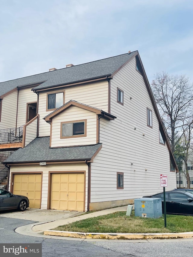 view of home's exterior with a balcony and a garage