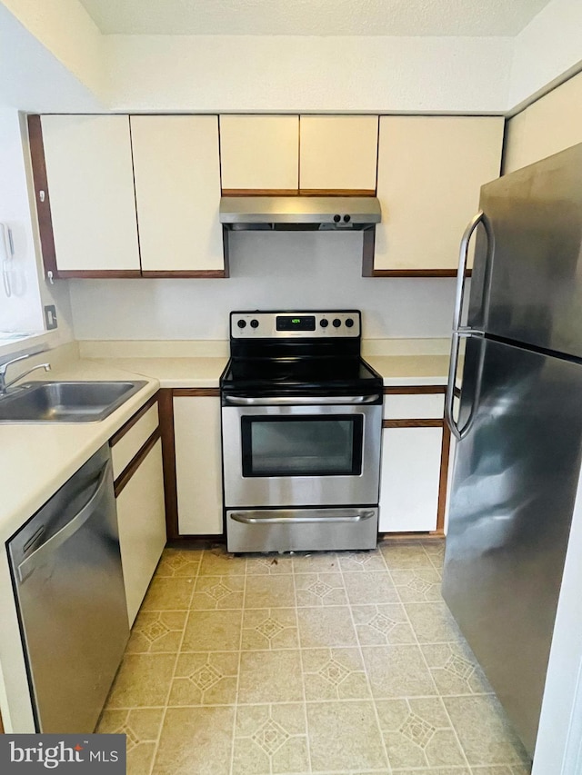 kitchen featuring light tile patterned flooring, sink, and appliances with stainless steel finishes