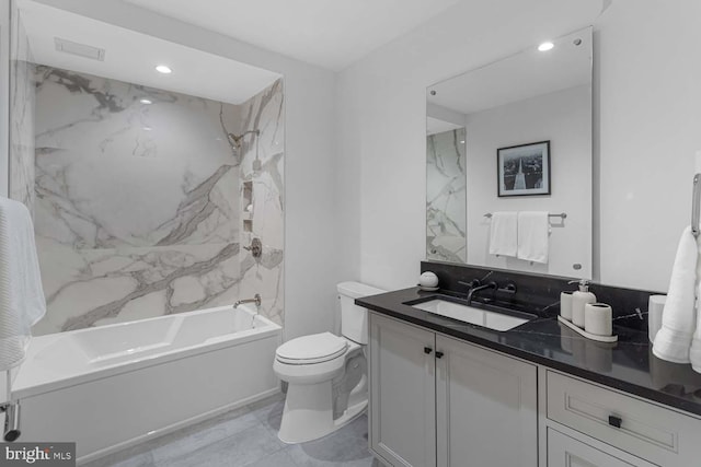 full bathroom featuring vanity, toilet, and tiled shower / bath