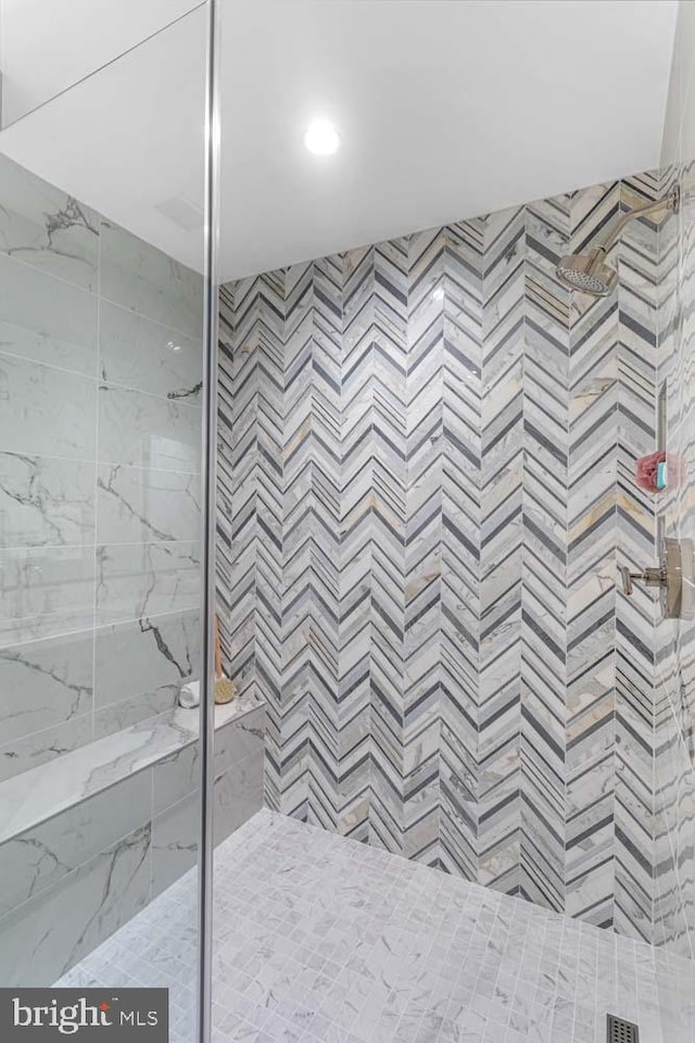 bathroom with a tile shower