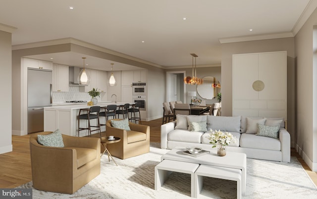 living room with light hardwood / wood-style floors, ornamental molding, a chandelier, and sink