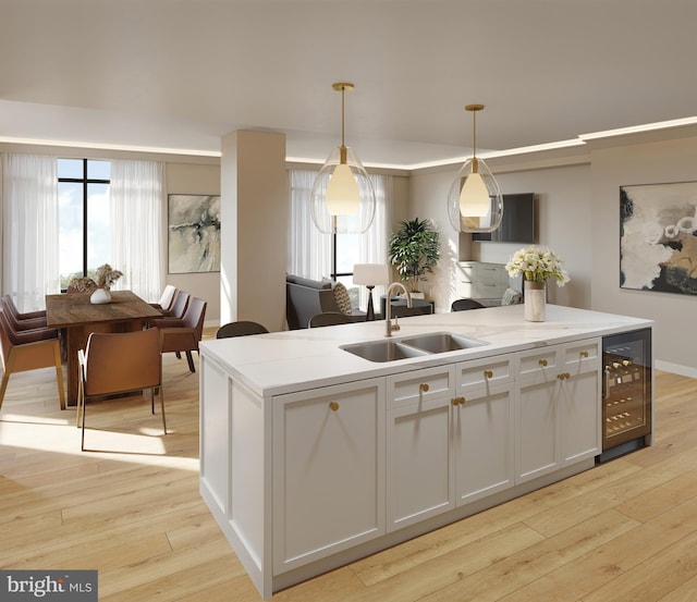 kitchen with wine cooler, white cabinetry, light wood-type flooring, pendant lighting, and sink