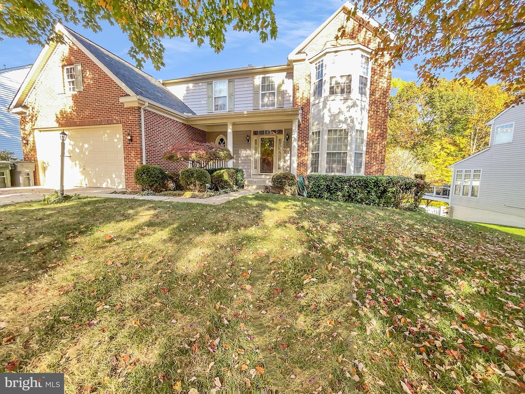 front of property featuring a front yard and a garage