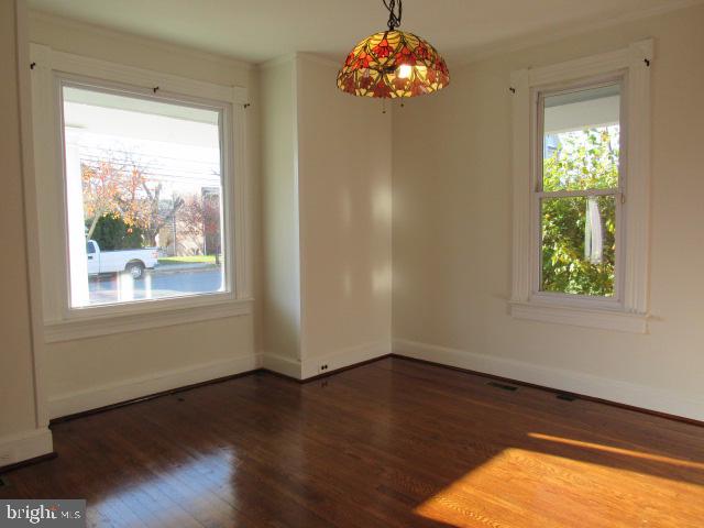 empty room featuring dark hardwood / wood-style flooring