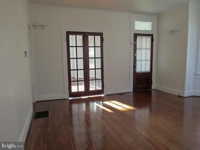 interior space featuring a wealth of natural light, french doors, and dark hardwood / wood-style flooring