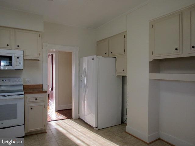 kitchen with white cabinets and white appliances