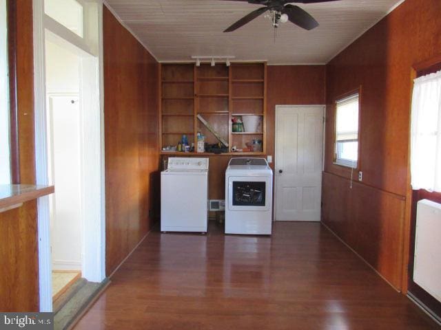 washroom with wooden walls, dark hardwood / wood-style floors, and independent washer and dryer