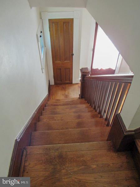 staircase featuring hardwood / wood-style floors