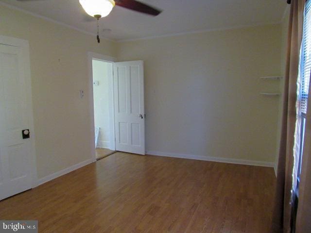 unfurnished room with hardwood / wood-style flooring, ceiling fan, and crown molding