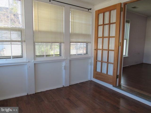 unfurnished room featuring dark hardwood / wood-style flooring